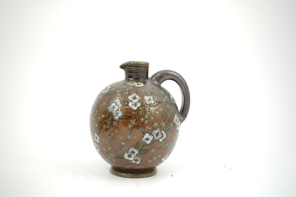 Martin Brothers: A stoneware jug decorated with flowers